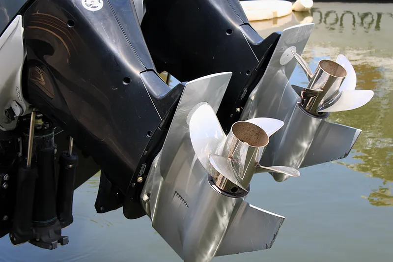 Slide: The Image of Twin outboard motors on a 2022 Formula 310 Bowrider OB, reflecting in water. - 36