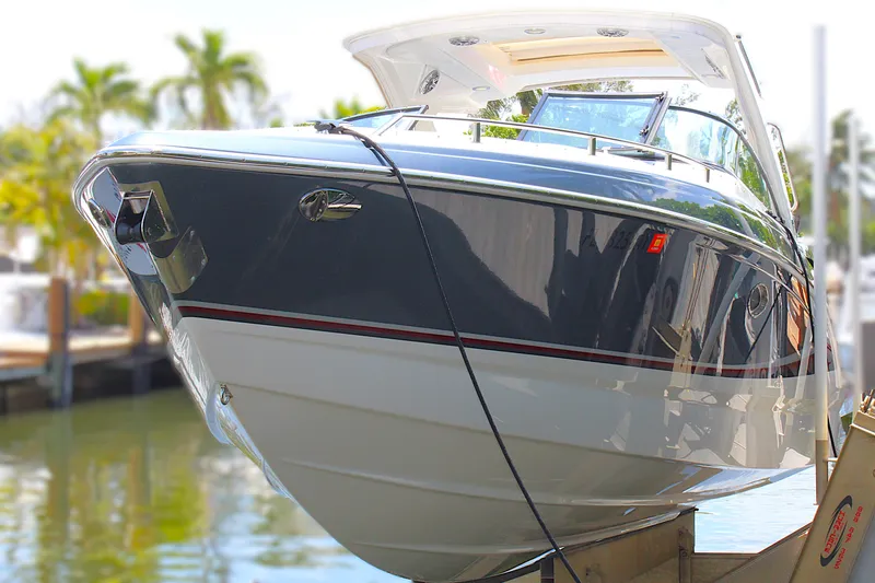 Slide: The Image of 2022 Formula 310 Bowrider OB boat docked, showcasing sleek design and modern features. - 38