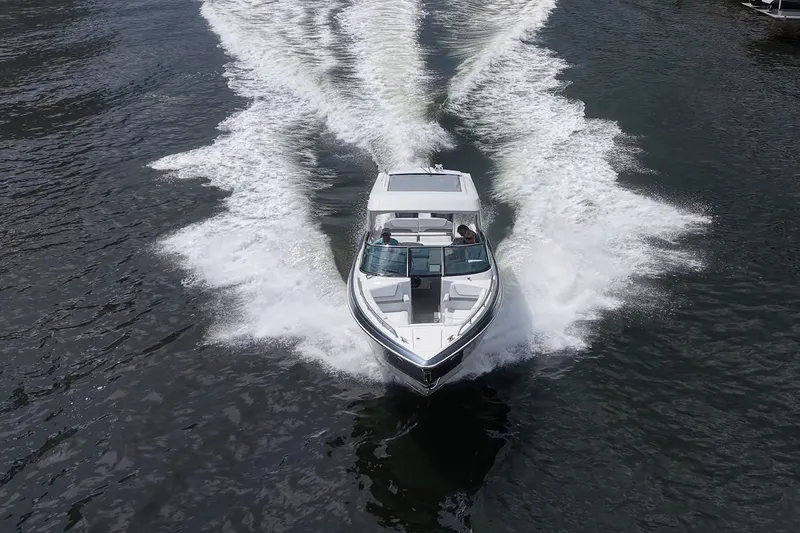 Slide: The Image of 2022 Formula 310 Bowrider OB cruising on water, creating dynamic wake patterns. - 33