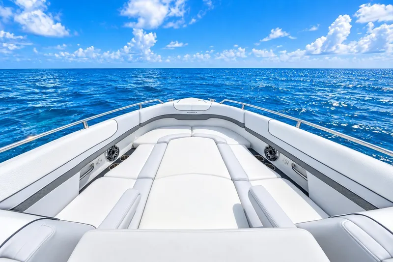 Slide: The Image of 2022 Formula 310 Bowrider OB on open sea, showcasing luxurious seating and clear blue skies. - 6