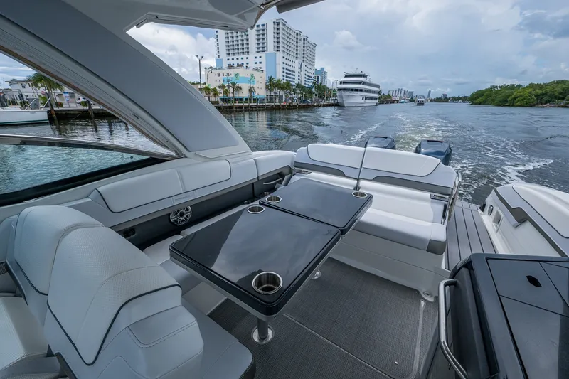 Slide: The Image of 2022 Formula 310 Bowrider OB interior with sleek seating and waterfront view. - 69