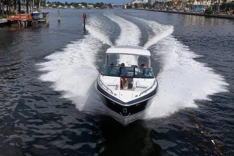 Slide: The Image of 2022 Formula 310 Bowrider OB cruising on a scenic waterway. - 23