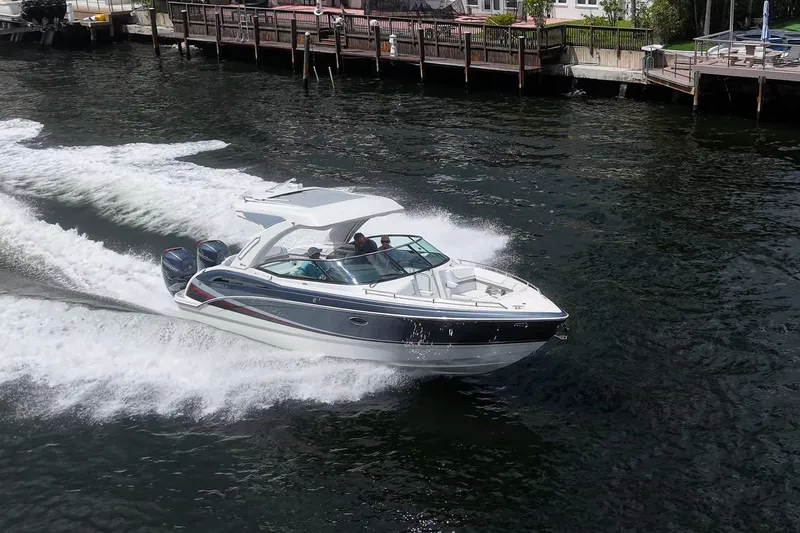 Slide: The Image of 2022 Formula 310 Bowrider OB cruising on water near a dock. - 30