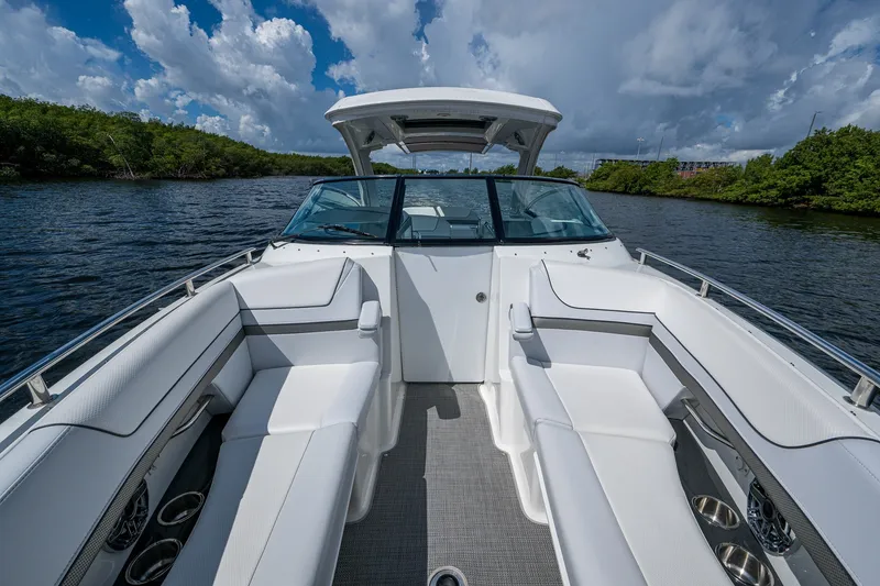 Slide: The Image of 2022 Formula 310 Bowrider OB on water, showcasing spacious seating and sleek design. - 54