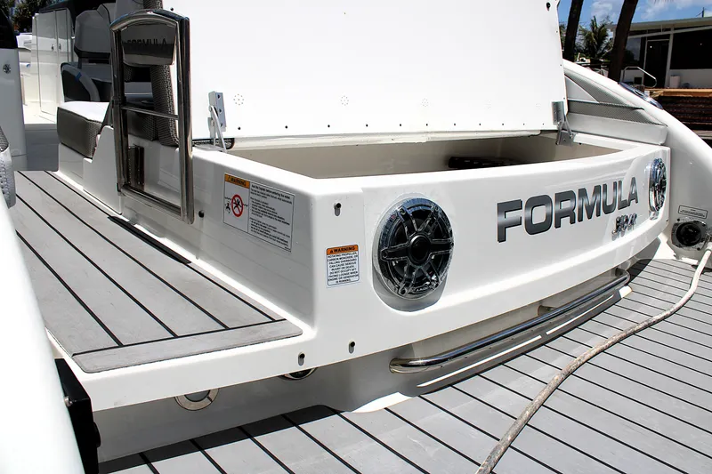 Slide: The Image of 2022 Formula 310 Bowrider OB boat with sleek deck and branded rear view. - 6