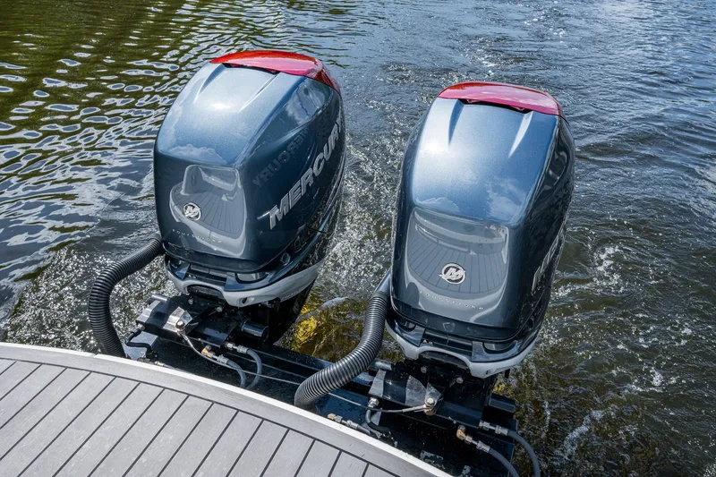 Slide: The Image of Twin Mercury outboard engines on a 2022 Formula 310 Bowrider OB, cruising on water. - 34