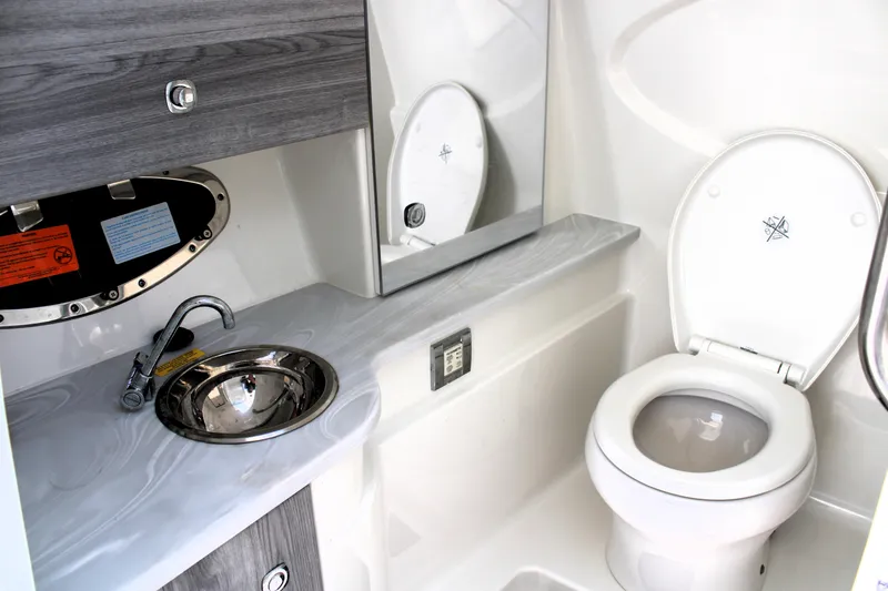 Slide: The Image of 2022 Formula 310 Bowrider OB boat bathroom with sink and toilet. - 7