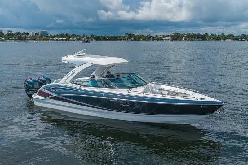 Slide: The Image of 2022 Formula 310 Bowrider OB cruising on a calm lake under cloudy skies. - 4