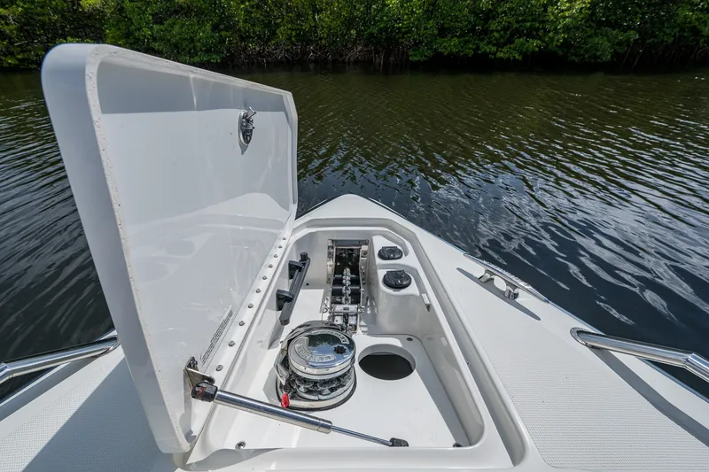Slide: The Image of 2022 Formula 310 Bowrider OB anchor compartment open, showcasing storage and mechanism. - 40