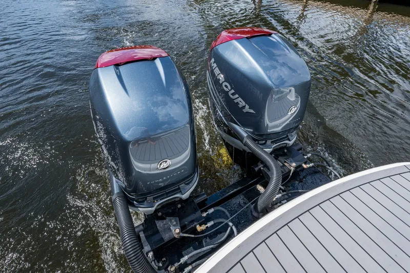 Slide: The Image of Twin Mercury outboard engines on a 2022 Formula 310 Bowrider OB in water. - 36