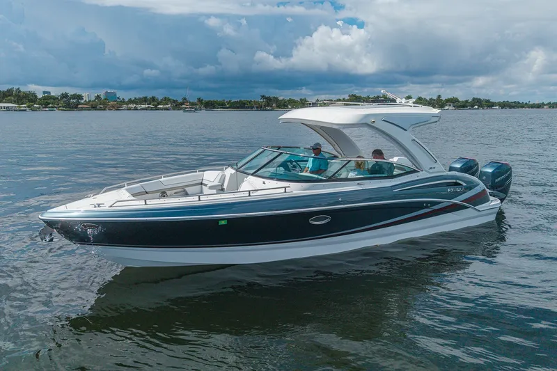 Slide: The Image of 2022 Formula 310 Bowrider OB cruising on a calm lake under a cloudy sky. - 9