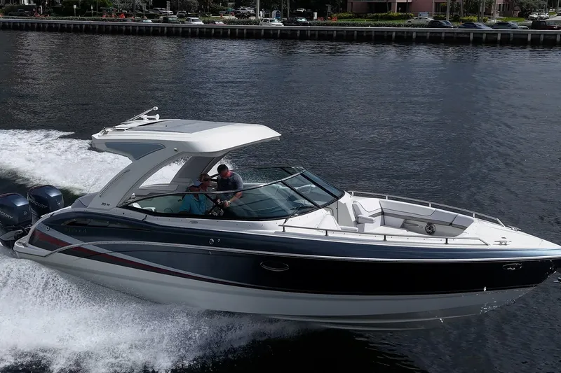Slide: The Image of 2022 Formula 310 Bowrider OB cruising on water, showcasing sleek design and powerful outboard engines. - 26