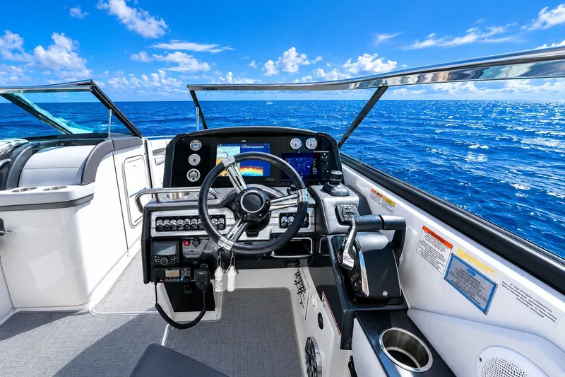 Slide: The Image of Cockpit view of 2022 Formula 310 Bowrider OB on open ocean, clear blue skies. - 9