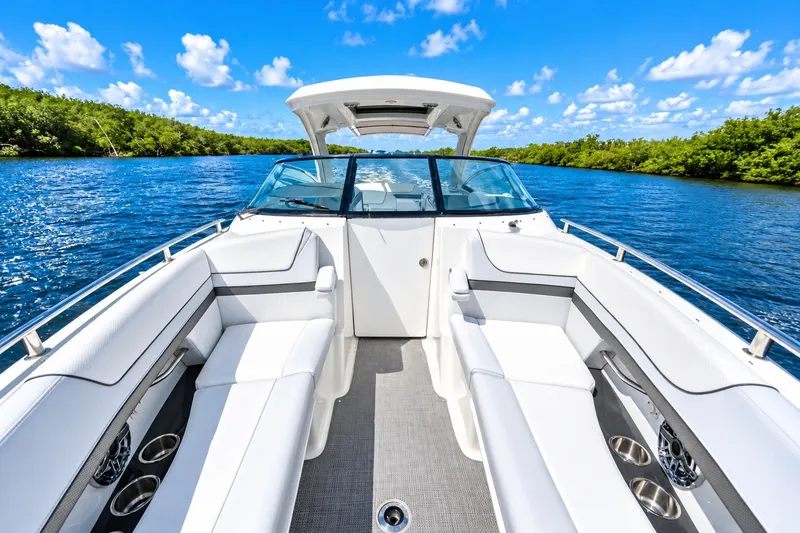 Slide: The Image of 2022 Formula 310 Bowrider OB on a scenic waterway, featuring luxurious seating and clear skies. - 3