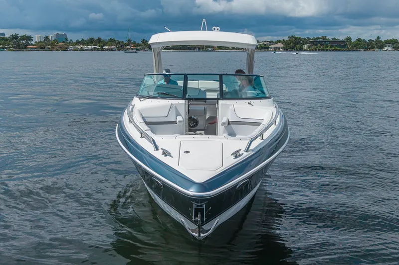 Slide: The Image of 2022 Formula 310 Bowrider OB on calm water, showcasing sleek design and spacious seating. - 7
