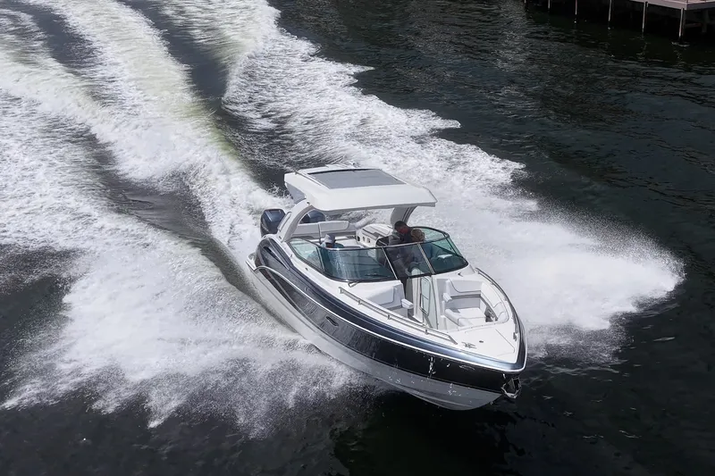 Slide: The Image of 2022 Formula 310 Bowrider OB cruising on water, creating dynamic wake patterns. - 32
