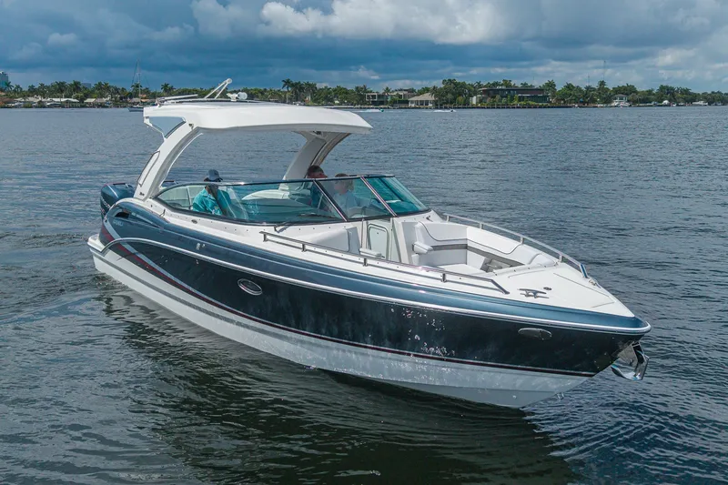 Slide: The Image of 2022 Formula 310 Bowrider OB cruising on a calm lake under cloudy skies. - 6