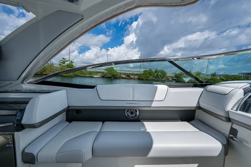 Slide: The Image of 2022 Formula 310 Bowrider OB interior with luxurious seating and scenic water view. - 53