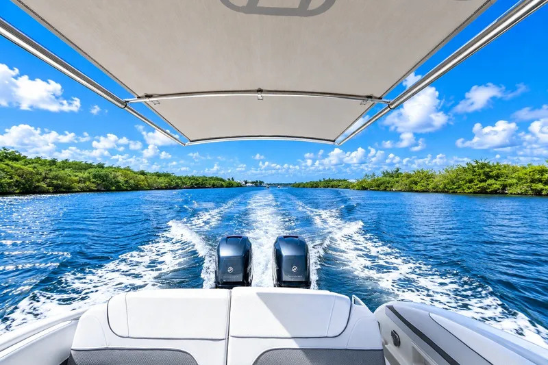 Slide: The Image of 2022 Formula 310 Bowrider OB cruising on a sunny day, leaving a wake behind. - 5