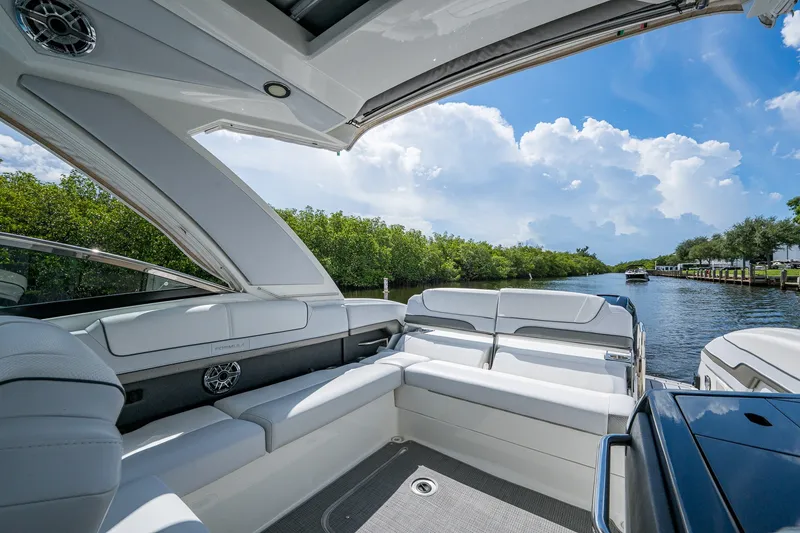 Slide: The Image of 2022 Formula 310 Bowrider OB interior with luxurious seating on a scenic waterway. - 46