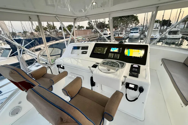 Slide: The Image of Helm of 2002 Viking 48 Convertible yacht with modern navigation equipment and dual captain chairs. - 10