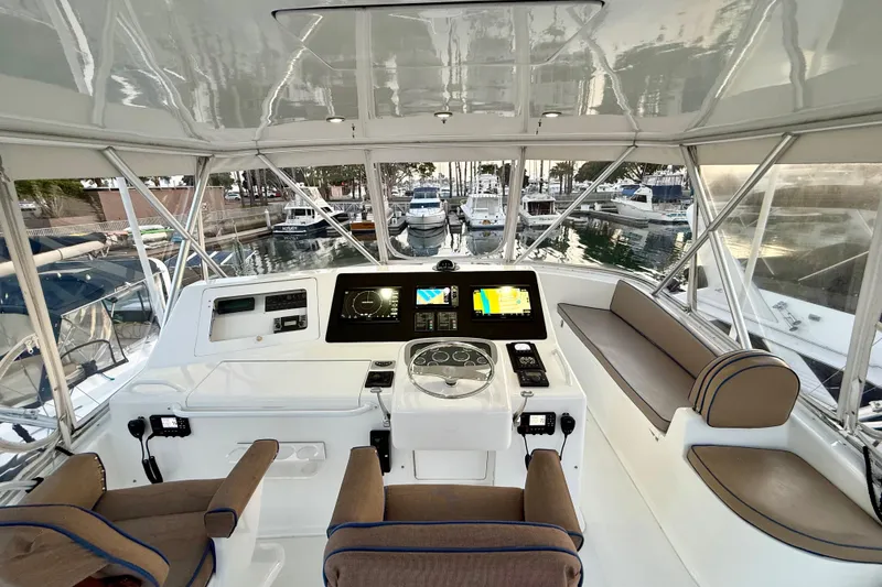 Slide: The Image of Helm of 2002 Viking 48 Convertible yacht with modern navigation equipment and seating. - 11