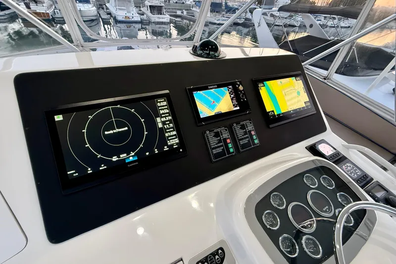 Slide: The Image of Control panel of a 2002 Viking 48 Convertible yacht with navigation displays. - 13