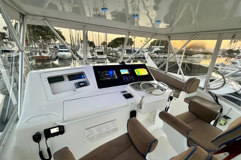 Slide: The Image of Helm of 2002 Viking 48 Convertible yacht with modern navigation equipment at sunset. - 14