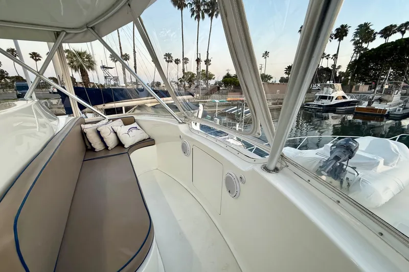 Slide: The Image of Luxurious seating area on a 2002 Viking 48 Convertible yacht, docked in a marina. - 16
