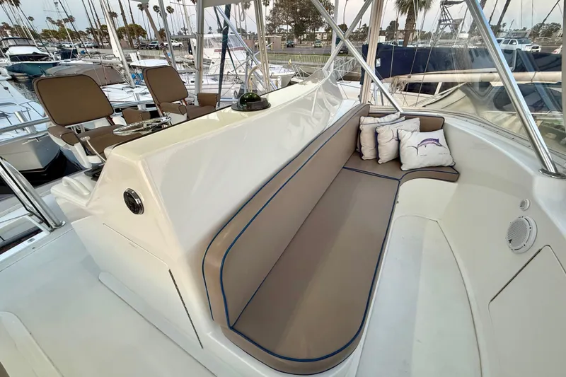 Slide: The Image of Luxurious seating area on a 2002 Viking 48 Convertible yacht, featuring plush cushions and helm chairs. - 17