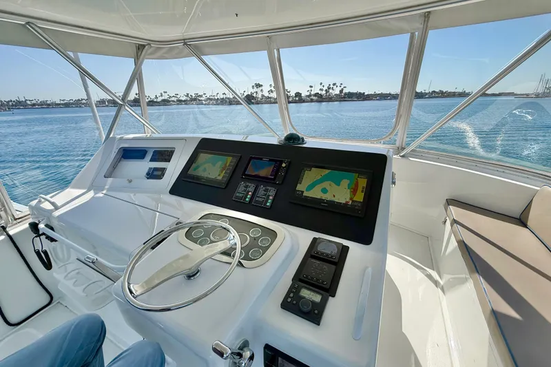 Slide: The Image of Helm of 2002 Viking 48 Convertible yacht with navigation screens and ocean view. - 20