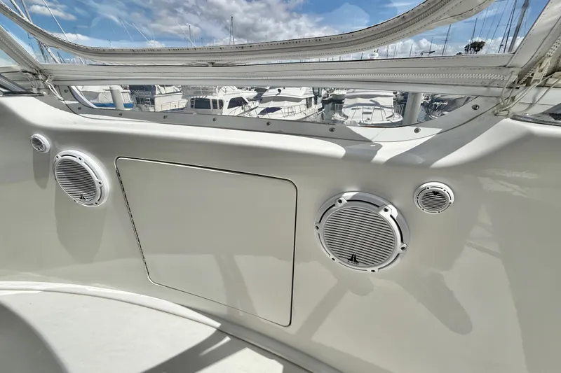 Slide: The Image of Interior view of a 2002 Viking 48 Convertible yacht with speakers and marina backdrop. - 21