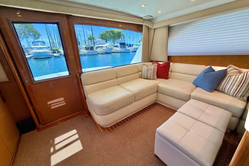 Slide: The Image of Luxurious interior of 2002 Viking 48 Convertible yacht with plush seating and marina view. - 24