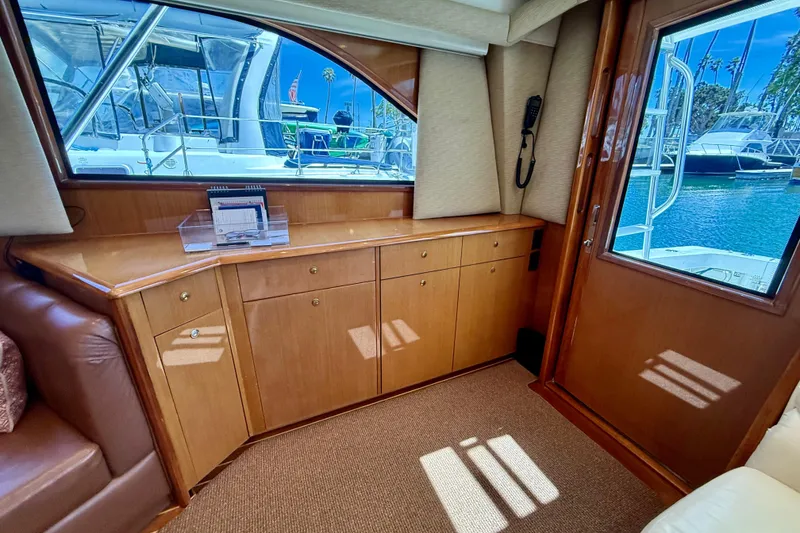 Slide: The Image of Interior of 2002 Viking 48 Convertible yacht with wooden cabinetry and marina view. - 28