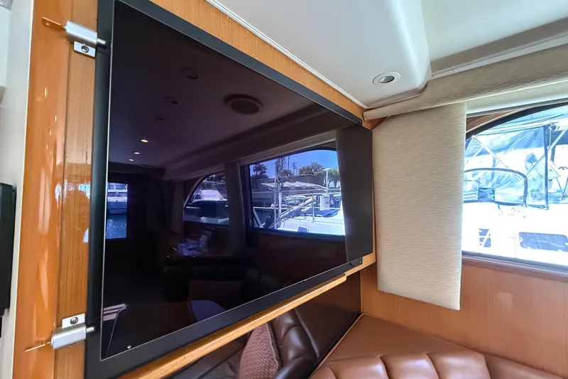 Slide: The Image of Interior of 2002 Viking 48 Convertible yacht with mounted flat-screen TV and window view. - 30