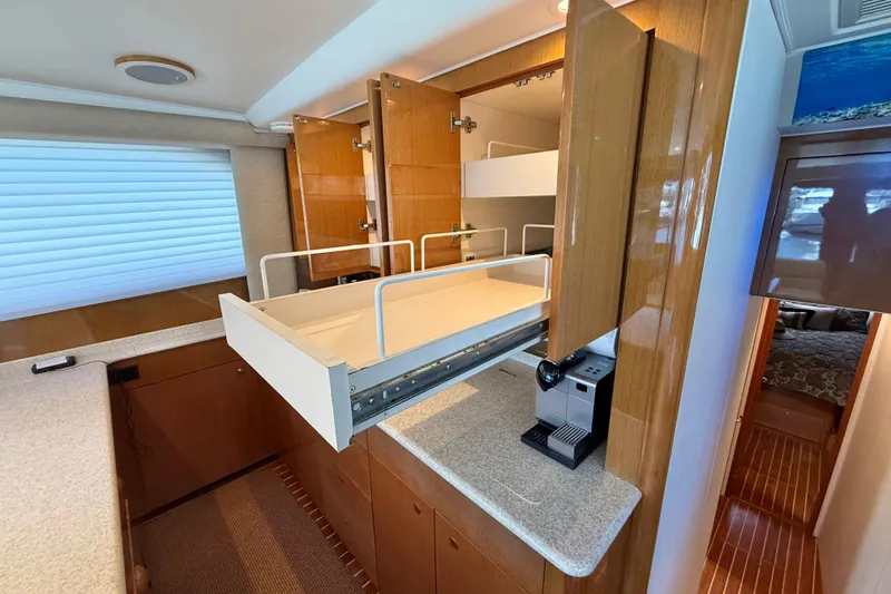 Slide: The Image of Interior of 2002 Viking 48 Convertible yacht with pull-out storage and coffee maker. - 33