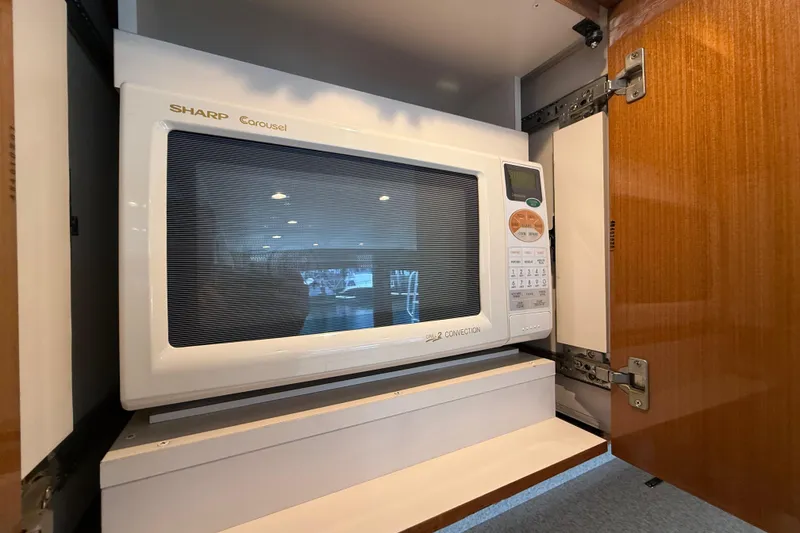 Slide: The Image of Sharp Carousel microwave in a wooden cabinet on a 2002 Viking 48 Convertible yacht. - 35