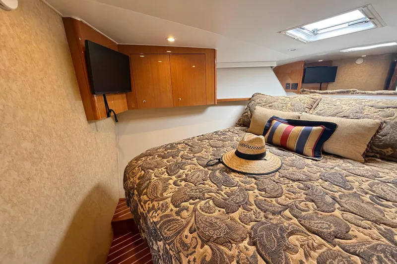 Slide: The Image of Luxurious cabin interior of 2002 Viking 48 Convertible yacht with elegant bedding and decor. - 41