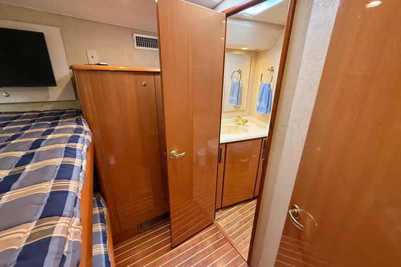 Slide: The Image of Interior of 2002 Viking 48 Convertible yacht with wood finish and cozy cabin. - 46