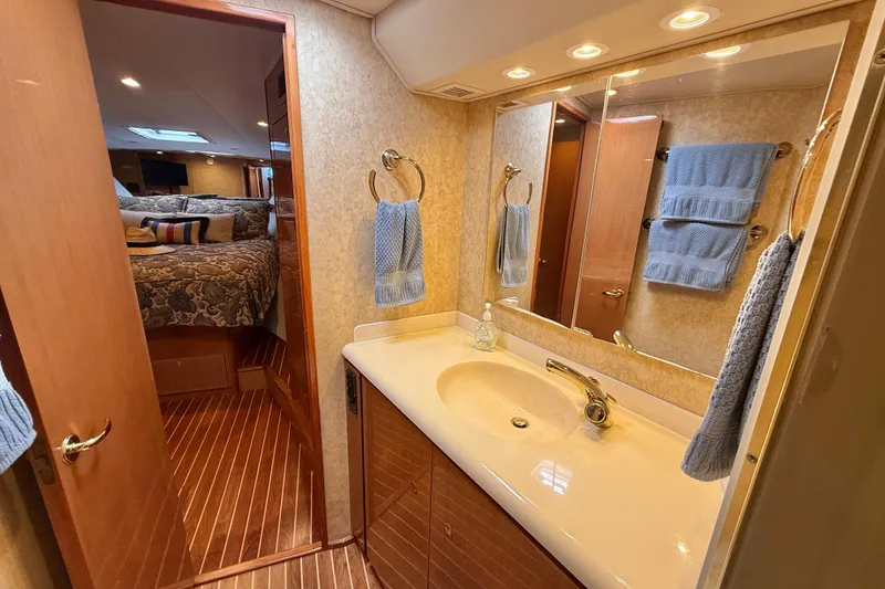 Slide: The Image of Luxurious bathroom and bedroom interior of 2002 Viking 48 Convertible yacht. - 48