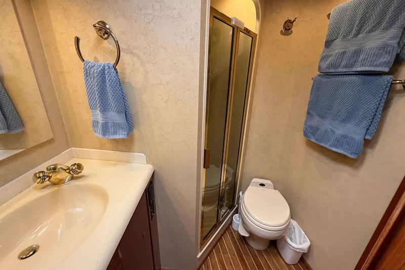 Slide: The Image of Bathroom interior of 2002 Viking 48 Convertible yacht with blue towels and shower. - 49