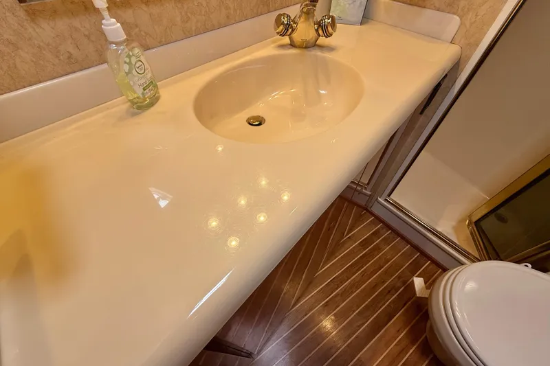 Slide: The Image of Bathroom sink and countertop in 2002 Viking 48 Convertible yacht. - 50