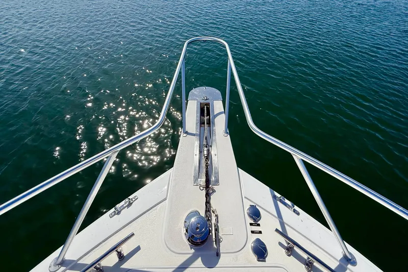 Slide: The Image of Bow view of 2002 Viking 48 Convertible yacht on sparkling water. - 55