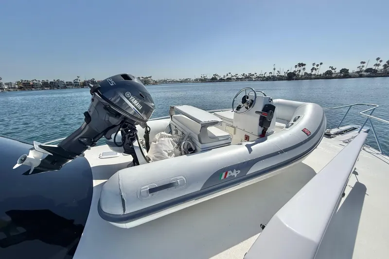 Slide: The Image of Inflatable boat with Yamaha motor on 2002 Viking 48 Convertible yacht deck. - 57