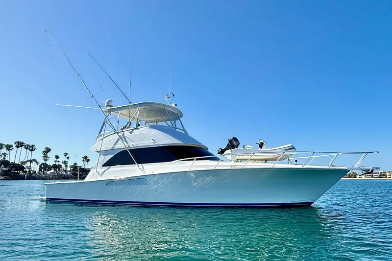Slide: The Image of 2002 Viking 48 Convertible yacht on calm water under clear blue sky. - 6