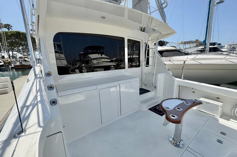 Slide: The Image of 2002 Viking 48 Convertible yacht deck with fishing chair and marina view. - 61