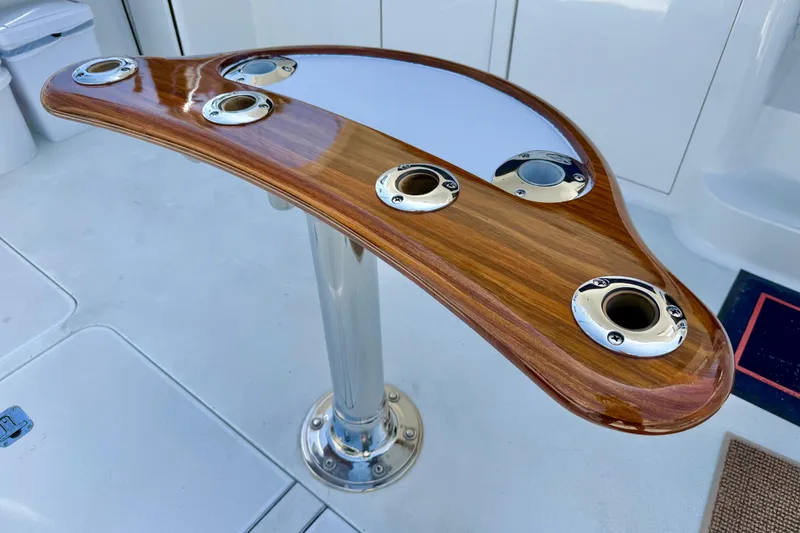 Slide: The Image of Polished wood and metal fishing rod holder on 2002 Viking 48 Convertible yacht. - 63