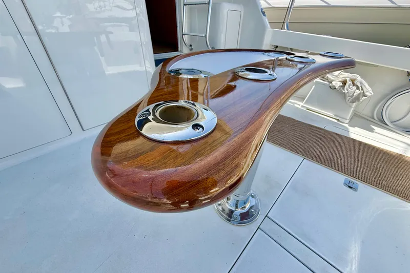 Slide: The Image of Luxurious wooden fishing rod holder on a 2002 Viking 48 Convertible yacht deck. - 64