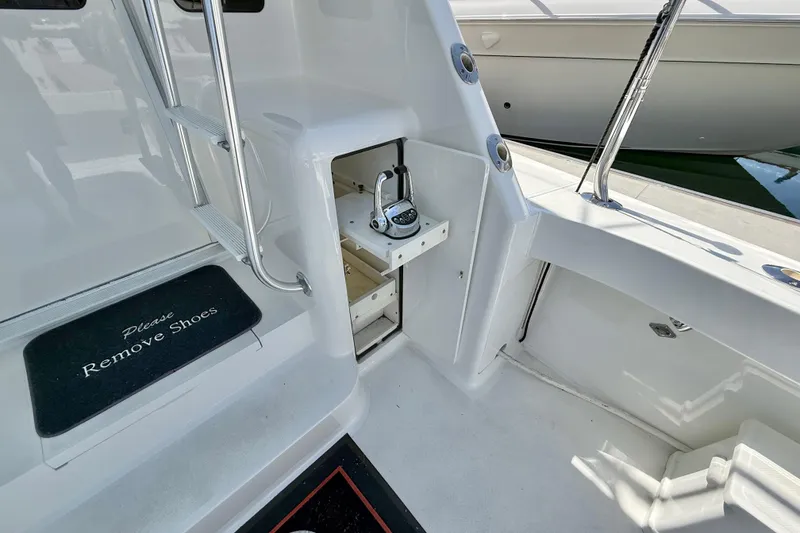 Slide: The Image of 2002 Viking 48 Convertible yacht interior with ladder, storage, and "Please Remove Shoes" mat. - 65
