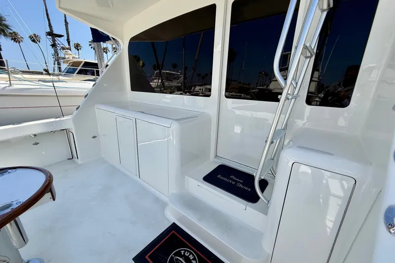 Slide: The Image of 2002 Viking 48 Convertible yacht deck with sleek white cabinetry and ladder. - 67